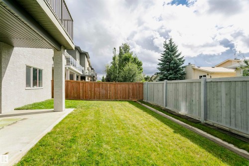 Expansive grassy yard with concrete patio and wood fencing - 9107 181 Avenue Nw, Edmonton, AB 