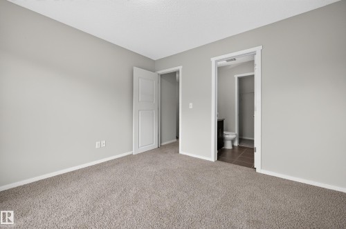 Carpeted flooring with light gray walls and white trim - #72 603 Watt Bv Sw Sw, Edmonton, AB 