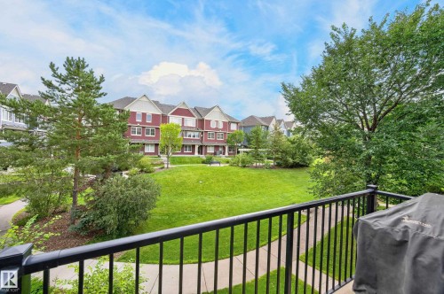 Expansive green space featuring mature trees and paved walking paths - #72 603 Watt Bv Sw Sw, Edmonton, AB 