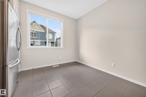 Tiled flooring, expansive window, neutral wall paint, white trim - #72 603 Watt Bv Sw Sw, Edmonton, AB 