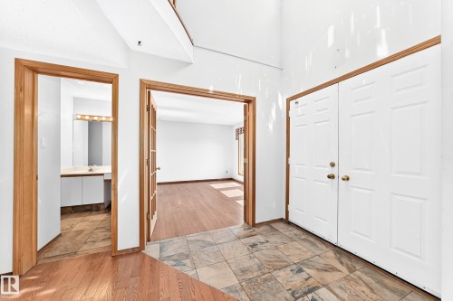 Entryway featuring a double door, mixed-material flooring, and wood-trim doorways - 4208 Ramsay Road Nw, Edmonton, AB 