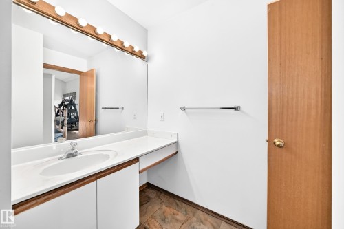 Vanity with an integrated sink, polished chrome faucet, and ample countertop space - 4208 Ramsay Road Nw, Edmonton, AB 