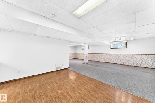 Expansive finished lower level featuring wood-finish flooring and carpeted areas - 4208 Ramsay Road Nw, Edmonton, AB 