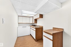 Built-in cabinetry with wood-finish countertops, overhead illumination, and wood-finish flooring - 