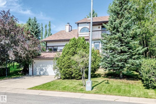 Two-story residence with a multi-car driveway, attached garage, and upper-level balcony - 4208 Ramsay Road Nw, Edmonton, AB 