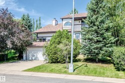 Two-story residence with a multi-car driveway, attached garage, and upper-level balcony - 