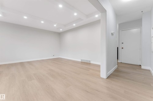 Recessed lighting illuminates the coffered ceiling and light wood-finish flooring - 7928 82 Avenue Nw, Edmonton, AB 