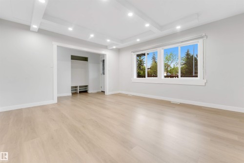 Recessed lighting, light wood-finish flooring, coffered ceiling, built-in entryway storage, and triple window - 7928 82 Avenue Nw, Edmonton, AB 