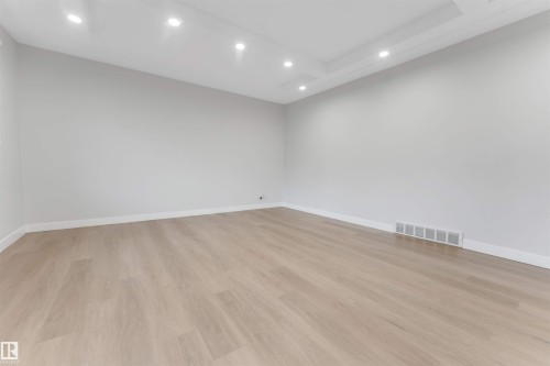 Recessed lighting, tray ceiling, light wood-finish flooring, and crisp white walls - 7928 82 Avenue Nw, Edmonton, AB 