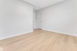 Light wood-finish flooring and neutral wall tones - 