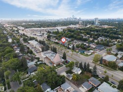 Aerial perspective showcasing residential streets, mature trees, and a distant city skyline - 