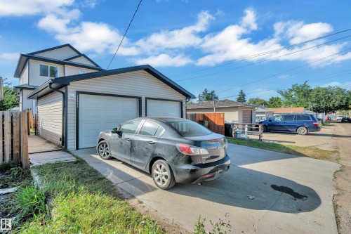 Two-car garage with overhead doors and concrete driveway - 11421 82 Street Nw, Edmonton, AB 
