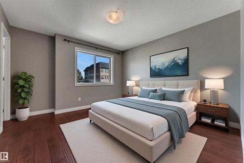 Warm wood-finish flooring, neutral wall tones, and a single window with a black curtain rod - 11421 82 Street Nw, Edmonton, AB 