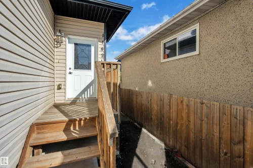 Entry porch with wood stairs and railing - 11421 82 Street Nw, Edmonton, AB 