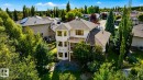 Multi-story stucco exterior with multiple balconies, a lower patio, and mature landscaping - 941 Picard Drive Nw, Edmonton, AB 