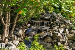 Tiered rock waterfall with flowing water feature - 