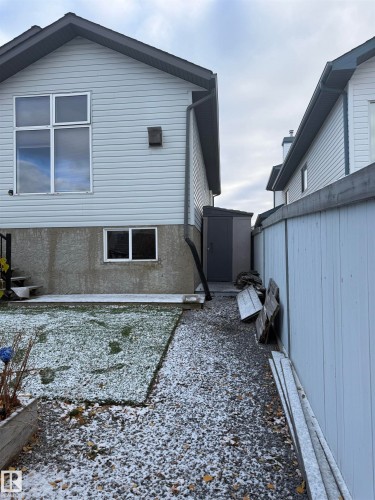 Light-colored siding exterior with dark trim and downspouts - 124 Ward Crescent Nw Nw, Edmonton, AB 