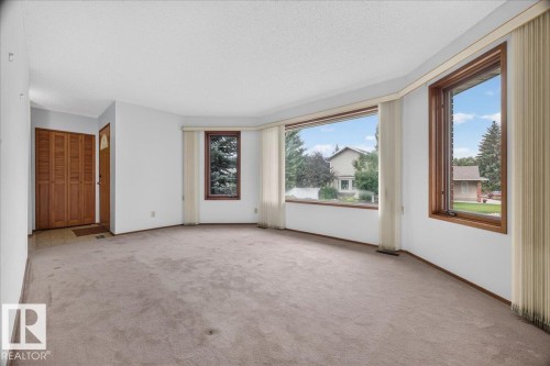Bay window with wooden frames, textured ceiling, and carpeted flooring - 2907 49 Street Nw, Edmonton, AB 