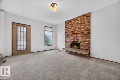 Brick fireplace with an arched firebox and wood mantel - 2907 49 Street Nw, Edmonton, AB 