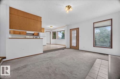 Functional kitchen with wood-finish cabinetry and white appliances - 2907 49 Street Nw, Edmonton, AB 