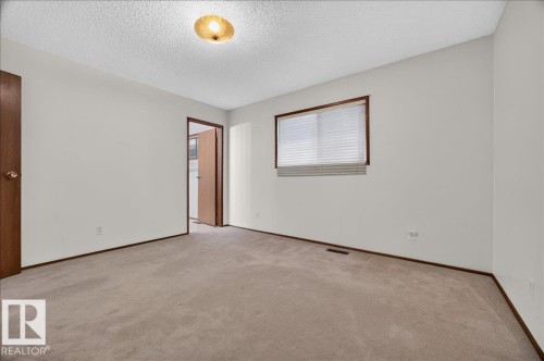 Wall-to-wall carpeting with light-toned walls - 2907 49 Street Nw, Edmonton, AB 