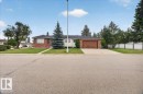 Brick exterior with a dark roof and a prominent front window - 2907 49 Street Nw, Edmonton, AB 