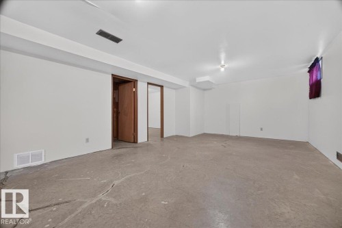 Spacious lower level with concrete flooring, recessed lighting, and white walls - 2907 49 Street Nw, Edmonton, AB 
