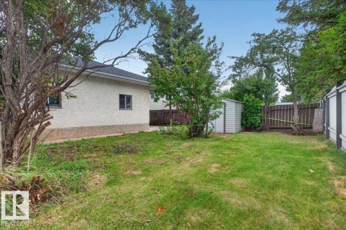 Expansive green lawn with mature trees and a storage shed - 2907 49 Street Nw, Edmonton, AB 