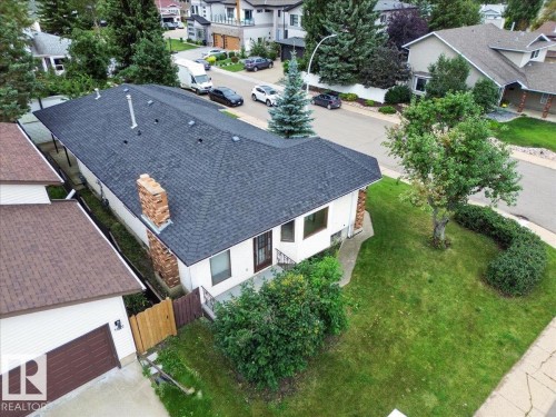 Dark shingle roofing and a brick chimney detail - 2907 49 Street Nw, Edmonton, AB 