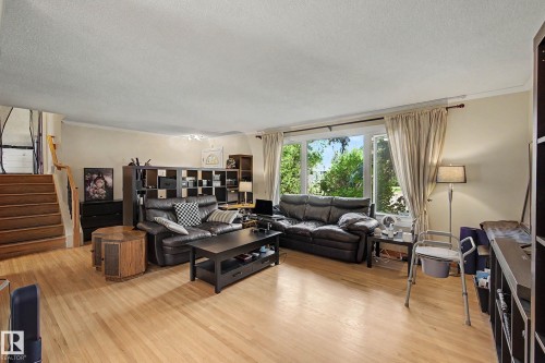 Hardwood flooring, large windows, and a built-in staircase - 11431 51 Avenue Nw, Edmonton, AB 