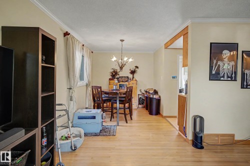 Hardwood-style flooring extends throughout, complemented by crown molding - 11431 51 Avenue Nw, Edmonton, AB 