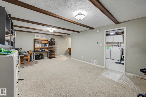 Carpeted room with exposed ceiling beams and recessed lighting - 11431 51 Avenue Nw, Edmonton, AB 