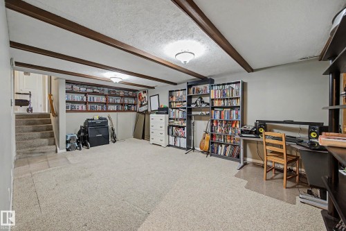 Exposed ceiling beams, recessed shelving, overhead lighting, and carpeted flooring - 11431 51 Avenue Nw, Edmonton, AB 