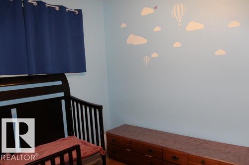 Light blue painted walls with decorative wall decals - 64 Apache Crescent, Leduc, AB 