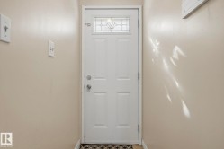 Entry door with decorative glass insert and polished door hardware - 