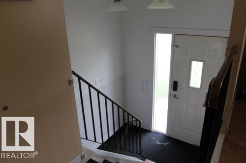 Entry door with decorative glass insert - 64 Apache Crescent, Leduc, AB 