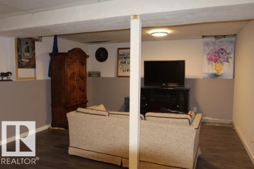 Wood-finish flooring with a two-tone painted wall design - 64 Apache Crescent, Leduc, AB 