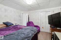 Light wood-finish flooring, white paneled walls, white bi-fold closet doors, and recessed ceiling lighting - 