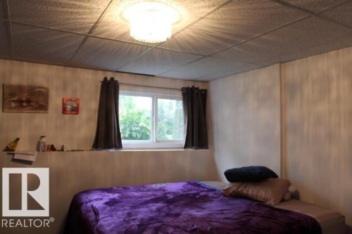 Recessed window with white frame, drop ceiling with recessed lighting - 64 Apache Crescent, Leduc, AB 