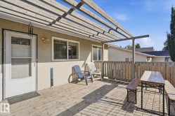 Wood-finish deck with a pergola-style overhead structure - 