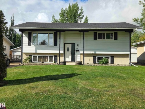 Split-level residence featuring a dark shingle roof and white siding - 64 Apache Crescent, Leduc, AB 
