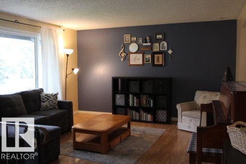 Wood-finish flooring throughout the space - 64 Apache Crescent, Leduc, AB 