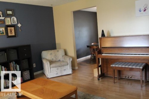 Wood-finish flooring throughout the main living space - 64 Apache Crescent, Leduc, AB 