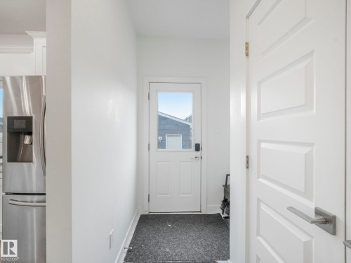 White interior door with brushed nickel hardware - 3807 Weidle Crescent Sw, Edmonton, AB 