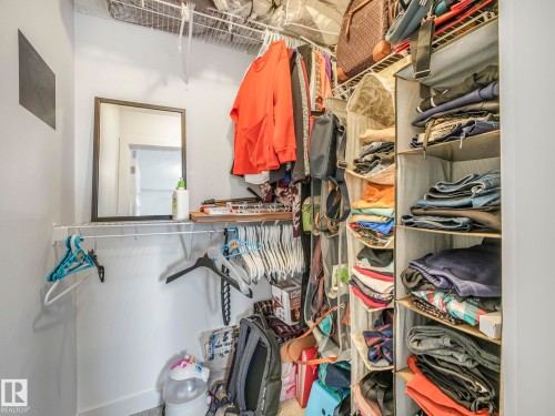 Built-in shelving units, wall-mounted mirror, and wire rack storage - 3807 Weidle Crescent Sw, Edmonton, AB 