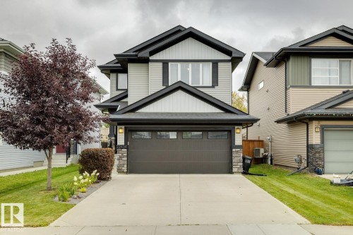 Contemporary exterior with light-toned siding and dark trim accents - 22434 99A Avenue Nw, Edmonton, AB 