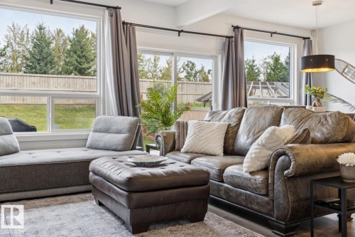 Recessed lighting and ceiling-mounted light fixture illuminate a bright room with multiple windows - 22434 99A Avenue Nw, Edmonton, AB 