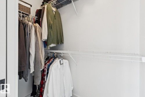 White wire shelving system with hanging rods - 22434 99A Avenue Nw, Edmonton, AB 