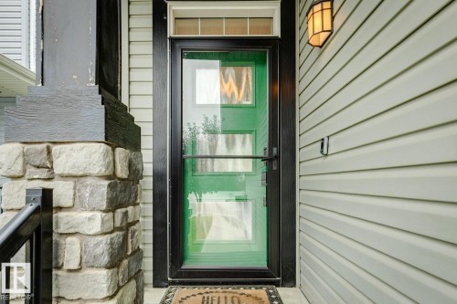 Light-colored horizontal siding complemented by stone pillar detailing - 22434 99A Avenue Nw, Edmonton, AB 