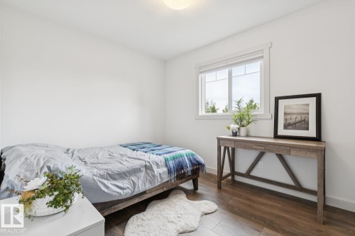 Recessed ceiling light, wood-finish flooring, white trim, and a window with white blinds - 22434 99A Avenue Nw, Edmonton, AB 